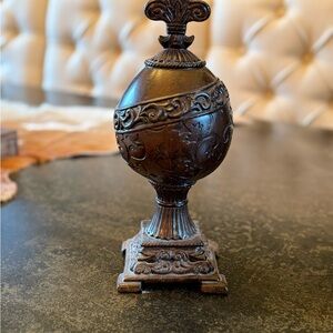 Ornate Brown Decorative Accent with Intricate Scrollwork and Vintage Texture